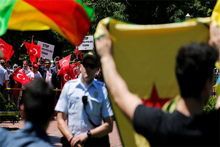 A group of pro-Erdogan demonstrators shout slogans at a group of anti-Erdogan Kurds in Lafayette Park, Washington, U.S. May 16, 2017.