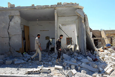 FILE PHOTO: Civil defense members inspect the damage at a site hit by airstrikes in the town of Khan Sheikhoun, Syria April 5, 2017