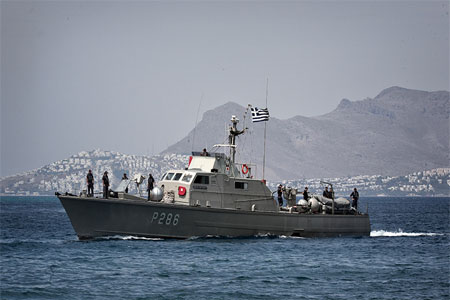 A Greek coast guard vessel returns after patrol to the port of Kos island , August 14, 2015