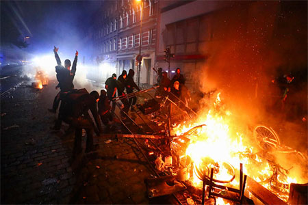 Barricades burn as protesters clash with riot police during the protests at the G20 summit in Hamburg, Germany, July 7, 2017