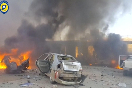Vehicles on fire at the site of a car bomb, said to be in the town of al-Dana, in Syria's rebel-held Idlib province.