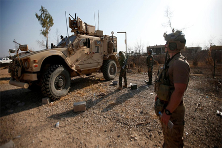 US military vehicles are seen in the town of Bashiqa, east of Mosul, during an operation to attack ISIS militants in Mosul, Iraq, November 7, 2016.