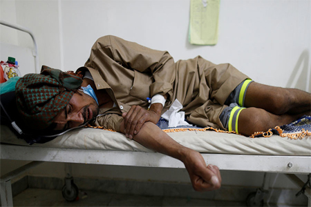 A man lies on the bed of a cholera treatment center in Sanaa, Yemen, May 15, 2017.