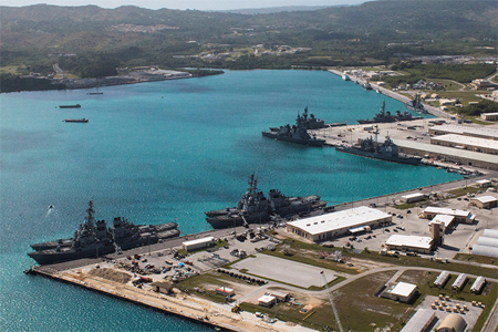 Navy vessels are moored in port at the U.S. Naval Base Guam at Apra Harbor, Guam