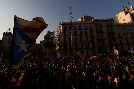 People raise hands and Estelada (Catalan separatist flag) during a demonstration two days after the banned independence referendum in Barcelona, Spain, October 3, 2017