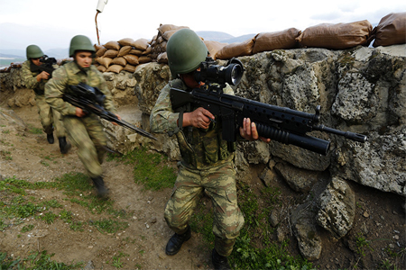 Turkish soldiers participate in an exercise on the border line between Turkey and Syria