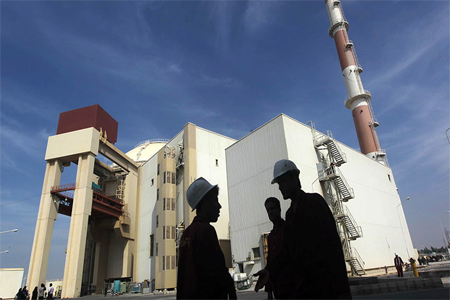 Iranian workers stand in front of the Bushehr nuclear power plant, about 1,200 km (746 miles) south of Tehran