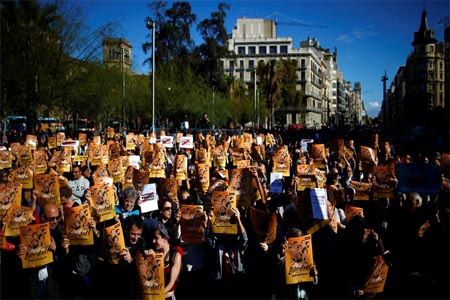 Demonstrators holding banners that read in Catalan: “Freedom for the Political Prisoners”, gather during a protest against the decision of a judge to jail ex-members of the Catalan government. (AP)