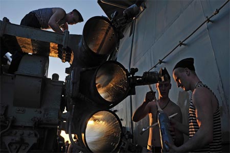 Sailors of nuclear-powered missile cruiser Pyotr Veliky painting rocket launch machine ahead of making port call in Tartus