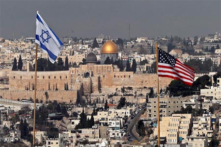 Israeli and US flags placed on the roof of an Israeli settlement building in East Jerusalem.