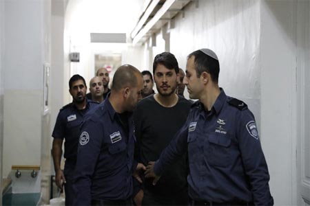 A Turkish tourist (C), who was arrested along with other two earlier in the week at a holy site in Jerusalem following Muslim prayers, is seen at an Israeli court in Jerusalem.