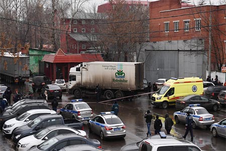 Police and ambulance at the scene of a fatal shooting at a confectionary factory in Moscow