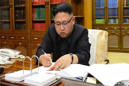 North Korean leader Kim Jong-Un signing the order to carry out the test-fire of the intercontinental ballistic missile Hwasong-14 at an undisclosed location.