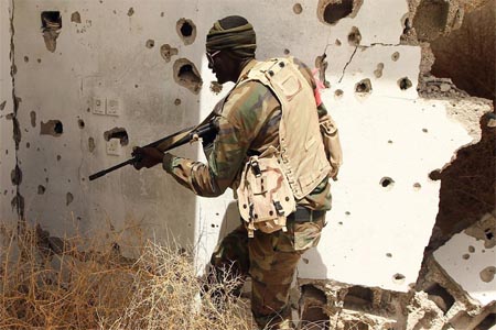 A member of the Libyan pro-government forces patrols a rural area on the outskirts of the eastern coastal city of Benghazi.