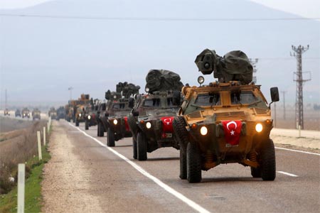 The Turkish army vehicles move to the city of Reyhanli located at the border between Turkey and Syria on February 13, 2018.
