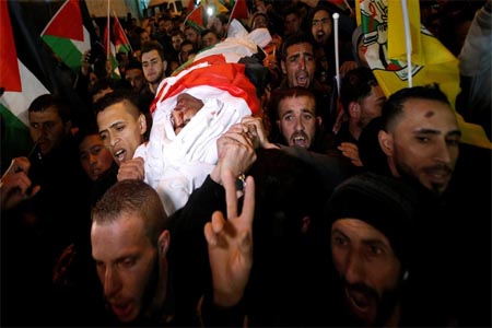 Mourners carry the body of Palestinian Mohammed al-Jabari during his funeral in Hebron, in the occupied West Bank on March 9, 2018.