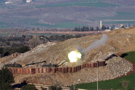 A plume of smoke rises on the air from inside Syria, as seen from the outskirts of the border town of Kilis, Turkey.