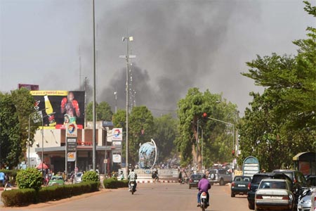 Smoke rises from the site of an armed attack in downtown Ouagadougou, Burkina Faso, on March 2, 2018