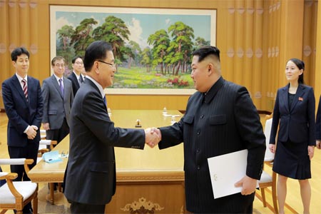 North Korean leader Kim Jong Un greets Chung Eui-yong, head of the presidential National Security Office, in Pyongyang, North Korea, March 6, 2018.