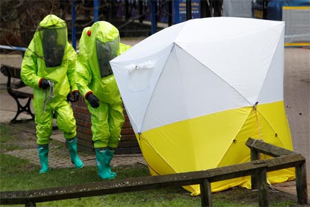 Officials in protective suits in the centre of Salisbury, Britain, March 8, 2018.