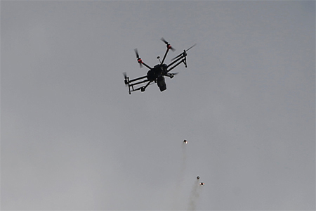 An Israeli drone drops tear gas grenades during clashes with Palestinians, during a tent city protest along the Israel border with Gaza, demanding the right to return to their homeland, east of Gaza City March 30, 2018.