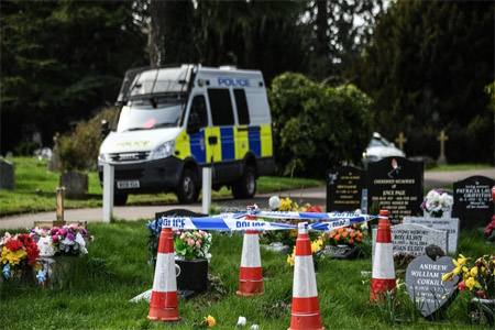 Police cars at the Salisbury cemetery where former Russian agent Sergei Skripal's spouse Lyudmila and son Alexander are buried