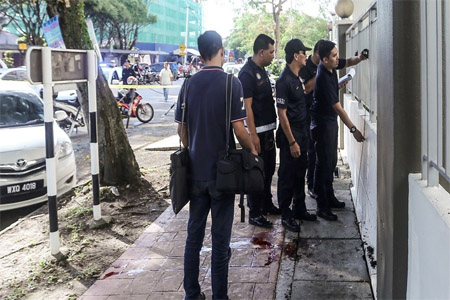 Malaysian forensic police collect evidence in the area where a Palestinian scientist was assassinated in Kuala Lumpur on April 21, 2018.