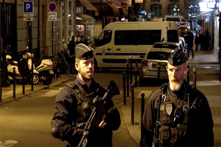Police guard the scene of a knife attack in Paris on May 12, 2018, in this still image obtained from a video.