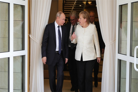 Vladimir Putin and Angela Merkel meet in Sochi.