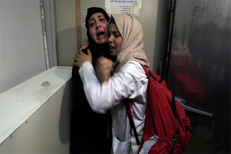 The aunt of 14-year-old Palestinian boy Yasser Abu Al-Naja, who was killed by Israeli forces at the Israel-Gaza border, reacts at a hospital morgue.