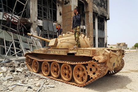 Members of the Libyan pro-government forces stand on a tank in Benghazi, Libya, May 21, 2015. (File Photo:Reuters)