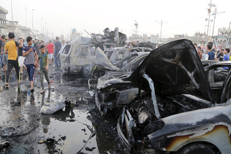 People look at damages at the site of a car bomb attack in Baghdad’s Sadr City August 5, 2015. The bomb killed six people and wounded 12, police and medics said. (Reuters)