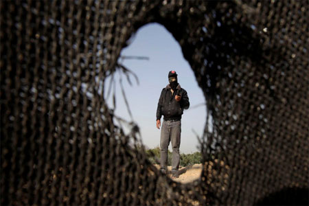 A Palestinian militant of the Democratic Front for the Liberation of Palestine (DFLP) inspects a training base after it was hit by an Israeli air strike in Rafah in the southern Gaza Strip April 28, 2013. (Reuters)