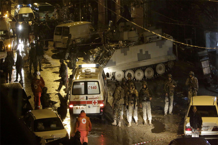 Lebanese security forces and emergency personnel gather outside a cafe targeted by a suicide bombing on Jan. 10, 2015 in the Jabal Mohsen.(AFP)
