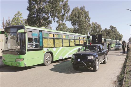 جنود سوريون يؤمنون خروج المسلحين من حي الوعر في حمص أمس (ا ف ب)