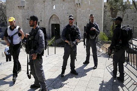 Israeli policemen stand guard outside Damascus Gate in Jerusalem's Old City, near the scene where, according to a police spokesperson, a Palestinian woman tried to stab Israeli border policemen, March 8, 2016.