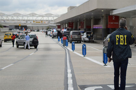 Law enforcement walk outside a terminal after a shooter opened fire at a baggage carousel at Fort Lauderdale-Hollywood International Airport in Fort Lauderdale, Florida, U.S., January 6, 2017