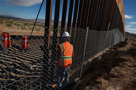 A U.S. worker builds a section of the U.S.-Mexico border wall at Sunland Park, U.S. opposite the Mexican border city of Ciudad Juarez