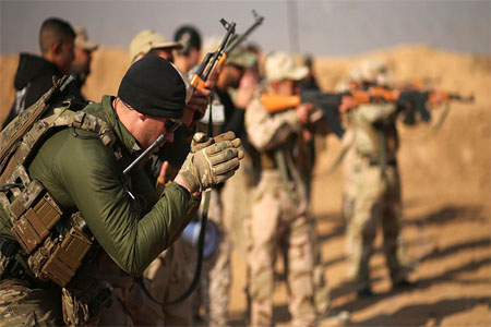 Members of the U.S. Army Special Forces provide training for Iraqi fighters from Hashid Shaabi at Makhmur camp in Iraq