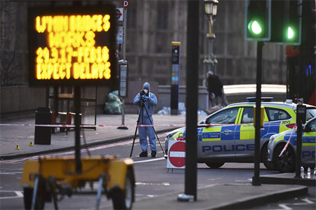 A forensics investigator works at the scene after an attack on Westminster Bridge in London, Britain March 22, 2017.